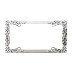 a silver metal frame with flowers and leaves on the bottom, in front of a white background