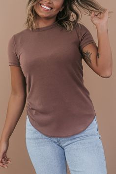 Our Basic Ribbed Tees are crafted from a stretchy ribbed fabric that is oh-so-comfortable. This piece features a full-length fit and a rounded hemline. An ideal basic meant for year-round wear. Neckline: Round Fabric: 65% Rayon, 30% Polyester, 5% Spandex Comfortable stretch Sizing (based on standard sizing): S (4/6) M (8/10) L (10/12) Designed with generous stretch fabrication and crafted to have a slimming true to size fit Model Specs: Emily is wearing a size small in the photo.How will this it Everyday Ribbed T-shirt, Solid Ribbed T-shirt For Layering, Ribbed Solid Stretch Tops, Stretch Solid Ribbed Top, Solid Stretch Ribbed Tops, Solid Ribbed Stretch Top, Stretch Solid Color Plain Tops, Stretch Plain Solid Color Tops, Stretch T-shirt For Layering