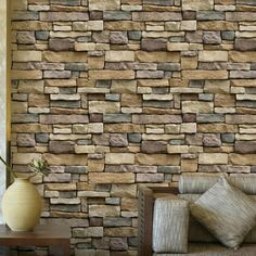 a living room with a couch and stone wall