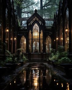 an old building with lots of windows and lights in the middle of it, surrounded by trees