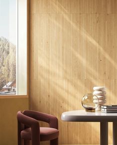 a chair and table in front of a window with the sun shining on it's side