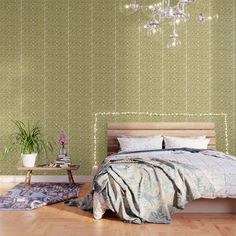 a bedroom with a bed, chandelier and rugs on the wooden floor