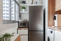 a kitchen with stainless steel appliances and wooden cabinets