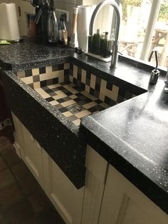 a black and white checkered counter top in a kitchen