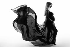 a pregnant woman in a flowing black dress