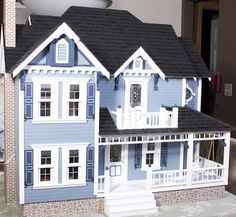 a paper model of a blue house with white trim