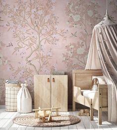 a bedroom with pink wallpaper and furniture in the corner, along with a baby's crib