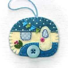 a close up of a small blue and white patchwork ornament with buttons