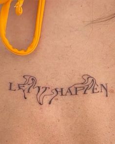 a woman with a tattoo on her back saying let's slapen in cursive writing