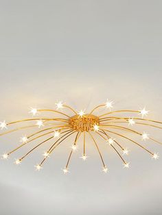 a ceiling light that has some lights on top of it and stars in the middle