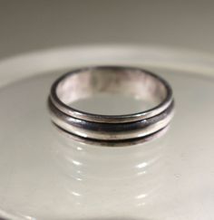 Elevate your style with this vintage men's silver ring! Crafted from sterling silver, this ring boasts a sleek and modern design that exudes sophistication. It features a double-banded design, and it has the 925 stamp on the inside. Perfect for everyday wear or special occasions; Approx. Measurements: 1 in x 1/4 in or 25mm x 6mm  Ring Size US: 11 1/2, Euro: 26 Approx. Weight: 6.4 g  If you have any additional questions, please take a look at our FAQs. To see more items in our store, please check out: https://www.etsy.com/shop/PrimaveraTrading. All your orders are always delivered gift-wrapped for free. Silver Classic Double Band Rings, Classic Silver Double Band Rings, Mens Silver Rings, Vintage Band, Wide Bands, Silver Man, Vintage Men, Etsy Vintage, Band Rings