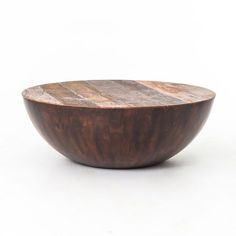 a wooden bowl sitting on top of a white table