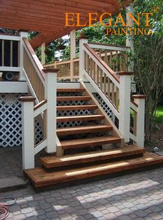 the stairs are made of wood and have white railings on each side, along with a pergolated roof