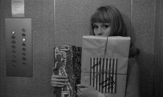 a woman hiding behind a paper bag with bars on it