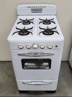 an old white stove with four burners