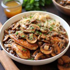 a white bowl filled with pasta and mushrooms