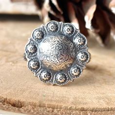 Want 20% off this item?  Go here to claim your coupon code!  https://pintody.com/pages/discounts Please note this ring will take 3 to 10 days to be made depending on our work load.  Elevate your style with our stunning Sterling Silver Desert Flower Concho Ring, a true statement piece for cowgirls and women who adore bold, eye-catching jewelry. This handcrafted ring showcases a beautiful concho design, intricately detailed with a desert flower pattern that captures the rugged beauty and elegance of the Southwestern landscape. The band features a captivating swirl and flower motif, meticulously crafted to ensure every detail stands out. Made from high-quality sterling silver, this ring boasts a silver shine and durability, making it a timeless addition to any jewelry collection. Features: Southwestern Concho Rings As Gifts, Southwestern Style Concho Rings As Gifts, Western Style Concho Rings As A Gift, Southwestern Concho Ring As A Gift, Western Style Concho Rings For Gift, Silver Concho Rings Perfect For Gifts, Bohemian Silver Engraved Ring, Silver Concho Rings For Gift, Artisan Silver Ring With Concho