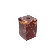 a brown marble block sitting on top of a white background