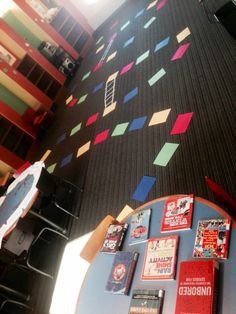 there are many books on the table in this room and it looks like they have been made out of paper