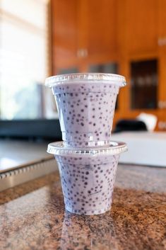 three plastic cups sitting on top of a counter