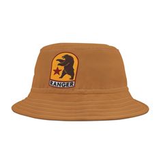 a tan ranger hat with a bear on it