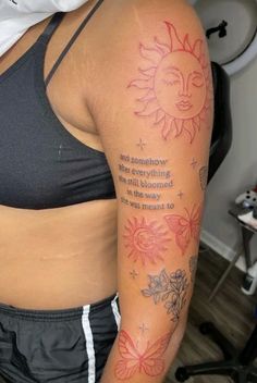 a woman's arm with a sun and flowers tattoo on the left side of her body