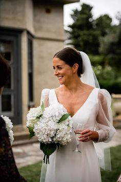 a woman in a wedding dress holding a bouquet