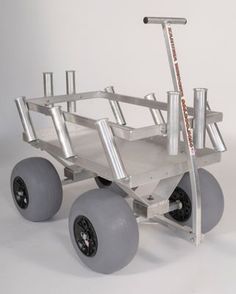 a small metal cart with four wheels and two large spokes on the front wheel