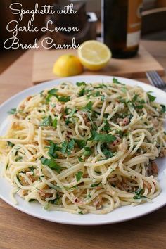 spaghetti with garlic and lemon bread crumbs on a white plate