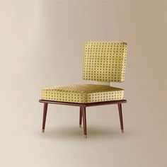 an upholstered chair with wooden legs and yellow patterned seat pad, against a neutral background