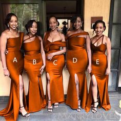 the bridesmaids are posing in their orange dresses