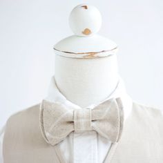 "Stylish and Dapper Natural Linen Windowpane Bow Tie Made By The Belle And The Beau! ♥ Beautiful linen/cotton blend yarn dyed woven fabric! Our boy's bow ties are made from 100% designer cotton fabric. They are perfect for any dapper day, Sunday best, special occasions, weddings, photography sessions, or polo and jeans. We are crushin' on this floral for your family photos and special events all year long! Each bow tie has a double layer for a dapper and preppy look. You have your choice of a qu White Fitted Bow Tie For Summer, White Bow Tie For Summer Wedding, Adjustable White Suit And Tie Accessories For Groom, Adjustable Fitted Bow Tie For Wedding, White Adjustable Suit And Tie Accessories For Wedding, Wedding Bow Tie With Adjustable Ties, White Bow Tie Back Ties For Wedding, White Adjustable Bow Tie Suit Accessories, Summer White Standard Bow Tie