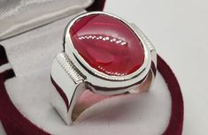 Deep Red Cabochon Ruby Sterling Silver 925 Handmade Ring Product Type: Ring Ring Size: 5 US, 6 US, 7 US, 8 US, 9 US, 10 US, 11 US, 12 US, 13 US, 14 US, 15 US, 16 US Stone Type: Ruby, Yaqoot, Rubin, Yaqut, Rubis, Roby Metal Type: Sterling Silver 925 Main Stone: Ruby Main Stone Color: Red Handmade: Yes, Artisan Ring Type: Heated & Treated (Lab Created) This Sterling Silver Ring is a perfect gift for men and women. The ring showcases an elegant design with unique Ruby stone. Get it for your loved one, or treat yourself for a classic timeless style. All orders come in a special gift box. Please contact us if you don't see your size. We will do our best to obtain it from our warehouse or resize when possible. Customer Policy: ● Your satisfaction is our priority. ● We guarantee you our products Ruby Cabochon Round Jewelry, Fine Jewelry Red Cabochon Ruby Ring, Silver Signet Ring With Bezel Setting As Gift, Silver Signet Ring With Bezel Setting For Gift, Hallmarked Ruby Oval Cabochon Ring, Hallmarked Ruby Ring With Oval Cabochon, Oval Cabochon Ruby Jewelry With Bezel Setting, Oval Cabochon Ruby Ring With Hallmark, Polished Oval Cabochon Ruby Jewelry