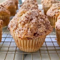 muffins with powdered sugar on top cooling on a rack