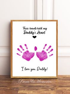 a pink handprint with the words, i love you daddy and dad on it