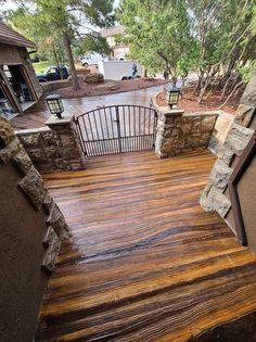 a wooden deck with stone walls and railings