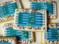 decorated cookies with blue and white frosting are arranged on a table