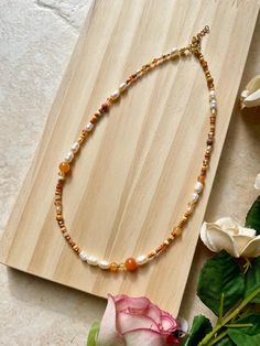 It is a handmade and colorful pearl necklace made of jade beads, Miyuki and freshwater pearls. 🌸 The warm colors, in combination with the high-quality freshwater pearls, form the perfect combination for autumn!💌 Of course, it is also the perfect gift idea for you or your girlfriend/mom/sister.  DESCRIPTION: Are you looking for a special yet high-quality necklace? Perfect! This light and colorful necklace is a perfect eye-catcher for you or your loved ones. 💖 Choose your own clasp color (gold or silver) and get started with your new favorite necklace! Note: If you choose "silver" as the clasp color, for example, the spacer beads will also be silver. The necklace is a MUST-HAVE for autumn or for a bit of colour in everyday life! 💖 MATERIALS AND DETAILS: At Aruba, each pearl is individual Handmade Brown Pearl Necklace Gift, Orange Pearl Necklace As A Gift, Beige Beaded Necklaces With Natural Stones As Gift, Beige Beaded Necklace With Natural Stones For Gift, Orange Pearl Necklace As Gift, Orange Pearl Necklace For Gifts, Orange Pearl Necklace For Gift, Gift Beige Beaded Necklace With Colorful Beads, Brown Pearl Necklace Gift