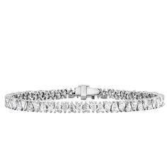 Think classic pear tennis bracelet but add in some extra brilliance. The alternating north-south set pear diamonds deliver massive sparkle and brilliance. Add a touch of edge to your wrist stack with this tennis bracelet. Total carat weight listed is based on 7 inch length (6.5 inch will weigh slightly less) Luxury Pear-shaped Diamond Bracelet With Diamond Accents, Luxury Pear-shaped Diamond Bracelet With Accents, Luxury White Gold Pear-shaped Diamond Bracelet, Luxury Pear-shaped White Gold Diamond Bracelet, White Gold Pear-shaped Diamond Bracelets, Pear-shaped Brilliant Cut Diamond Bracelet For Formal Occasions, Pear-shaped Diamond Bracelets In White Gold, Pear-shaped Diamond Bracelet With Brilliant Cut, Pear-shaped Brilliant Cut Diamond Bracelets