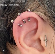 the ear is adorned with tiny silver beads and a cross on it's side