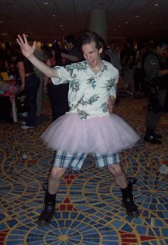 a man in a tutu is dancing on the floor