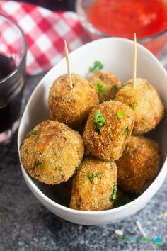 small appetizers in a white bowl with toothpicks sticking out of them