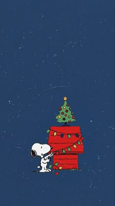 a charlie brown christmas card with a tree on top and a snoop bear leaning against it