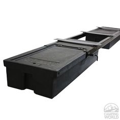 the bottom section of a black plastic container with two trays on each side and one lid