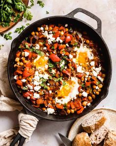 an iron skillet filled with eggs and vegetables