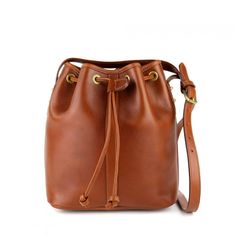 This open drawstring bucket bag is great for casual use and easy access. A handy interior zippered pocket and open leather pockets make it easy to keep your necessities easily accessible Hand Bags Ideas, Frank Clegg, Bags Ideas, Stylish Purse, Mini Bucket Bags, Bucket Bags, Mini Bucket, Drawstring Bucket Bag, Handcrafted Bags