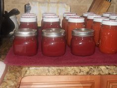 there are many jars with red liquid in them