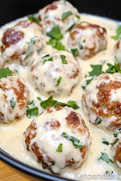 some meatballs are covered in sauce and garnished with parsley on top