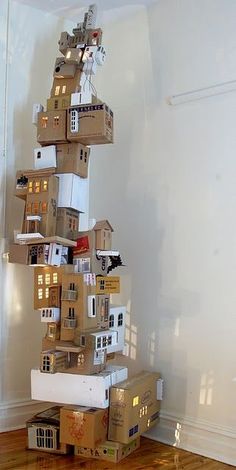 cardboard boxes stacked on top of each other in the shape of a house with windows