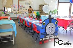 a train themed birthday party with balloons and tables